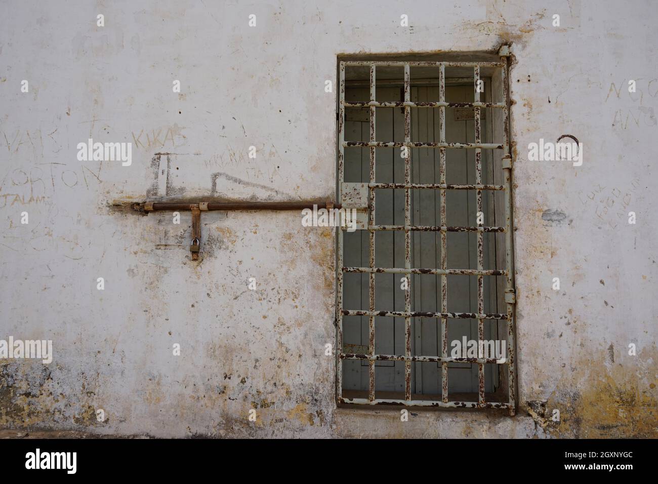 Barred, locked door, prisoners' quarters, Tarrafal concentration camp, Santiago Island, Republic of Cape Verde Stock Photo