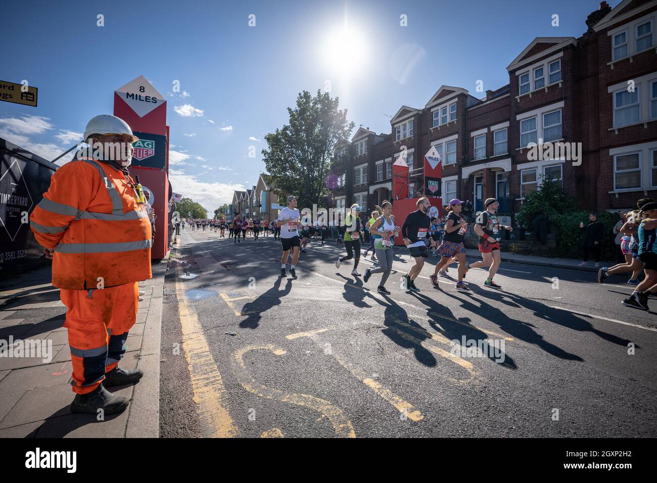 London Marathon passes down Deptford’s Evelyn Street in South East London, the 8 mile mark of the 26.2 mile course. London, UK. Stock Photo