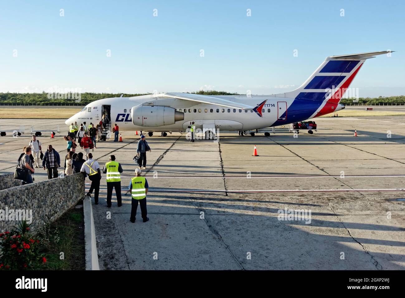 Passengers disembark Antonov An-158 regional jet, stretched version of An-148, Santiago de Cuba airport, Santiago de Cuba province, Caribbean, Cuba Stock Photo