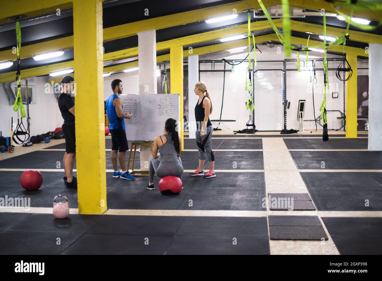 Training course.group of young athletes getting instructions from ...