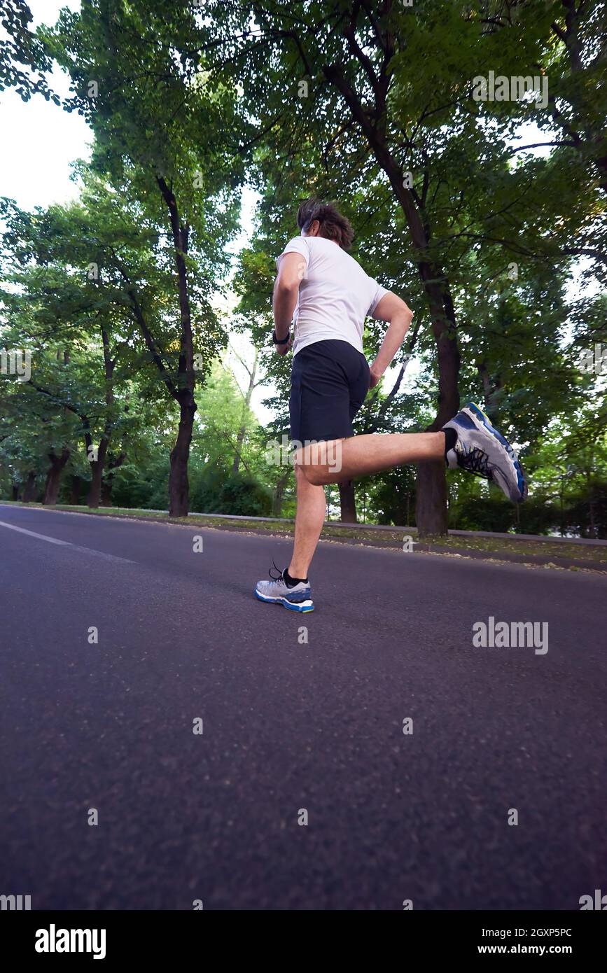 healthy athlete man jogging at morning on empty  roat in the city Stock Photo