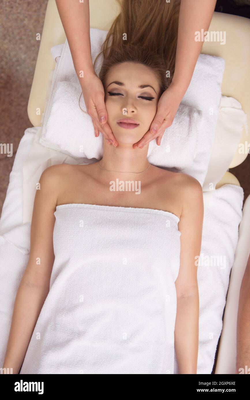 Young Beautiful Relaxed Woman Receiving A Head Massage In A Spa Centre