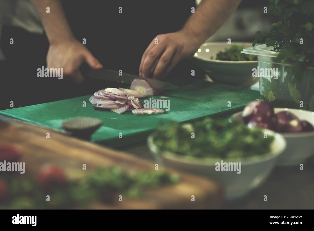 Chef hands cutting the onion with knife . Preparation for cooking ...