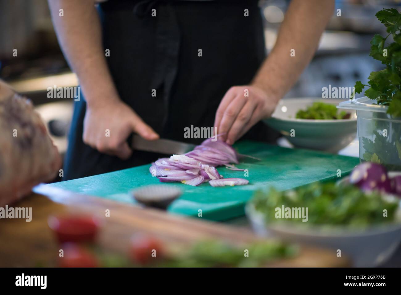 Chef hands cutting the onion with knife . Preparation for cooking ...