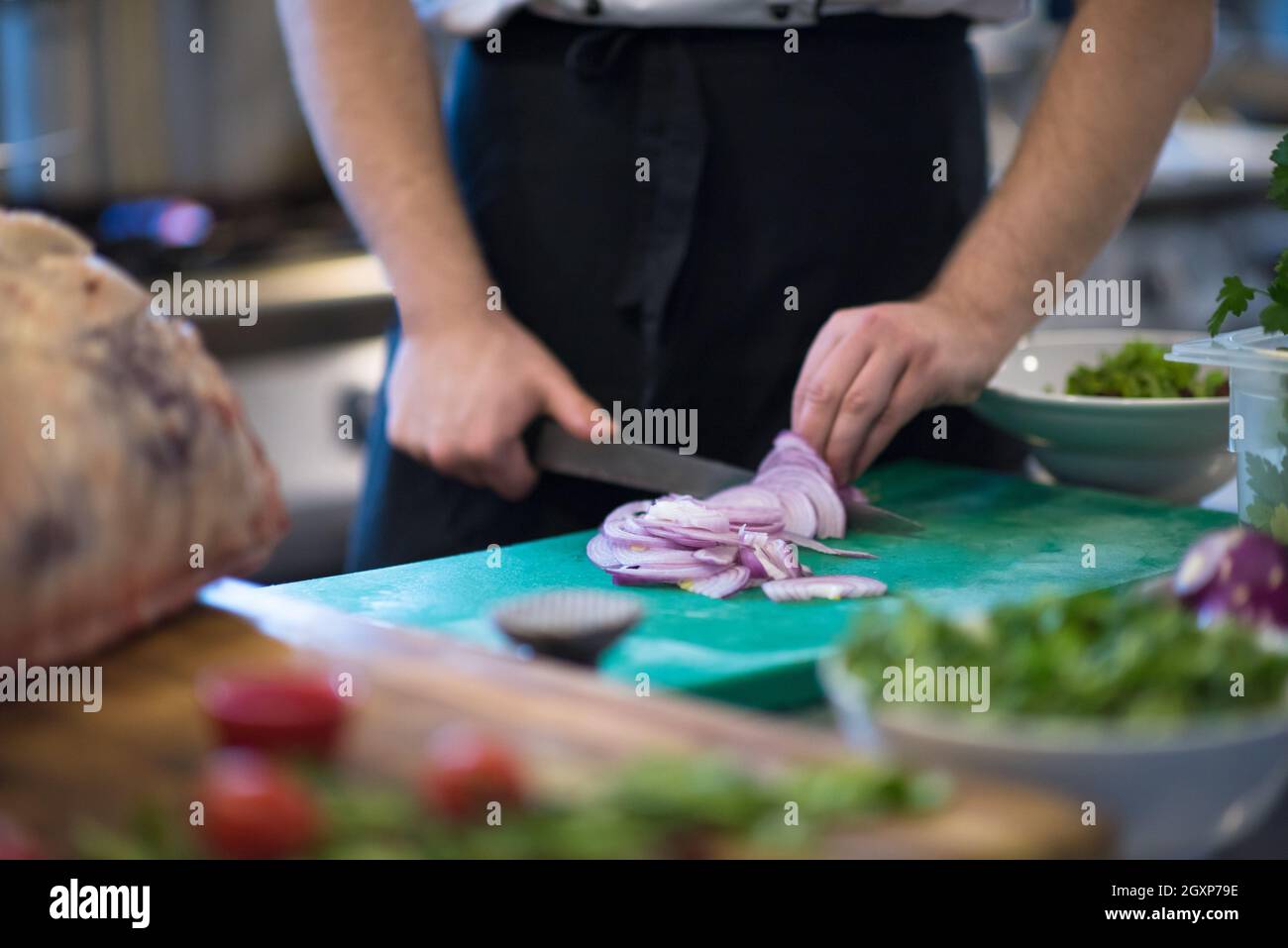 Chef hands cutting the onion with knife . Preparation for cooking ...