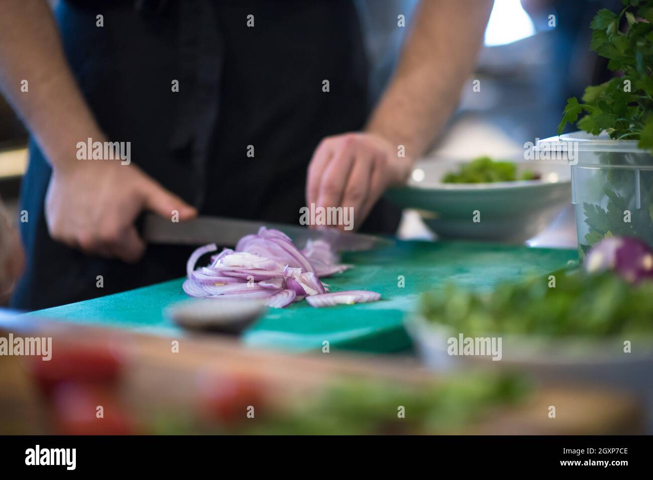 Chef hands cutting the onion with knife . Preparation for cooking ...