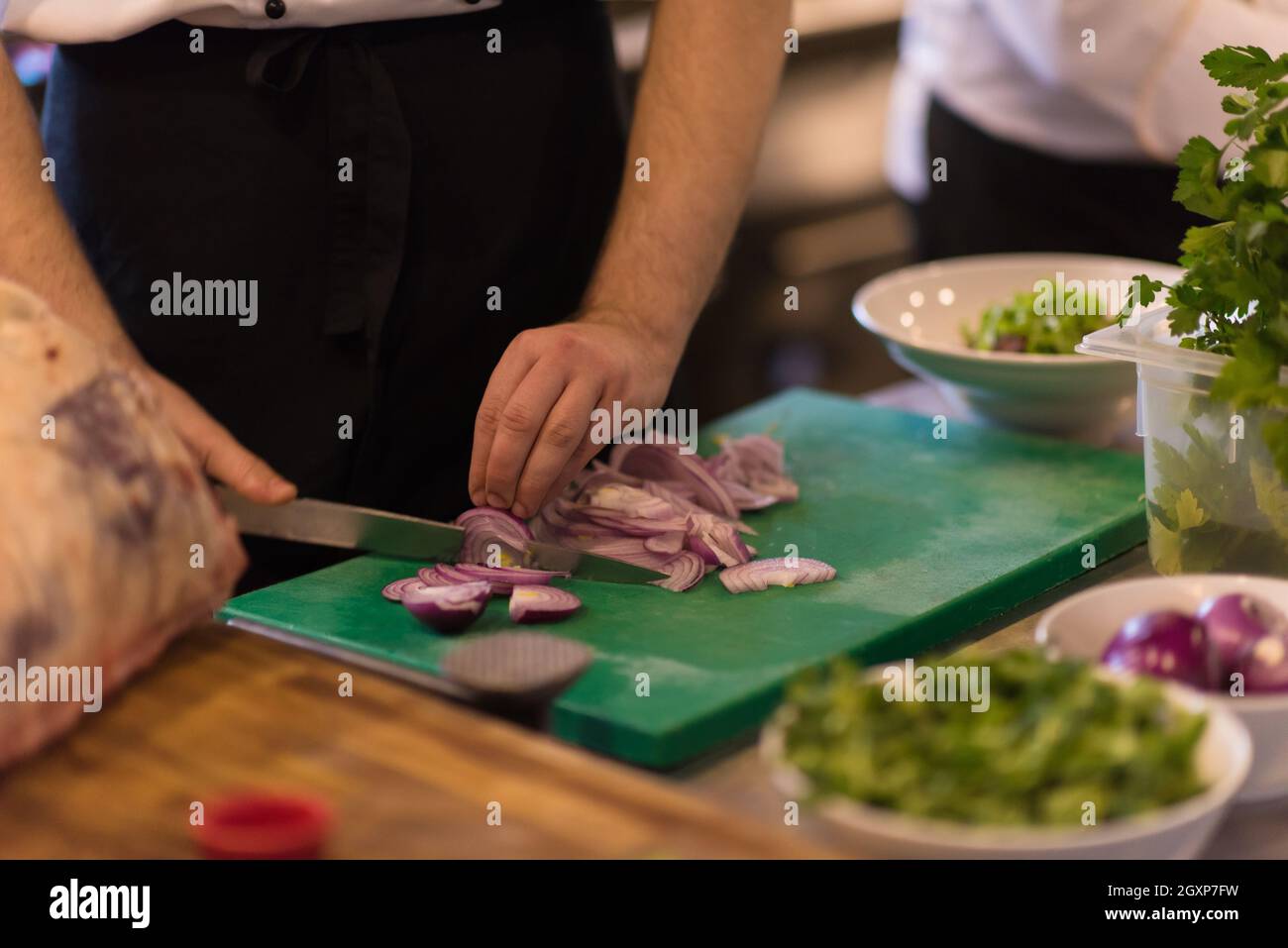 Chef hands cutting the onion with knife . Preparation for cooking ...