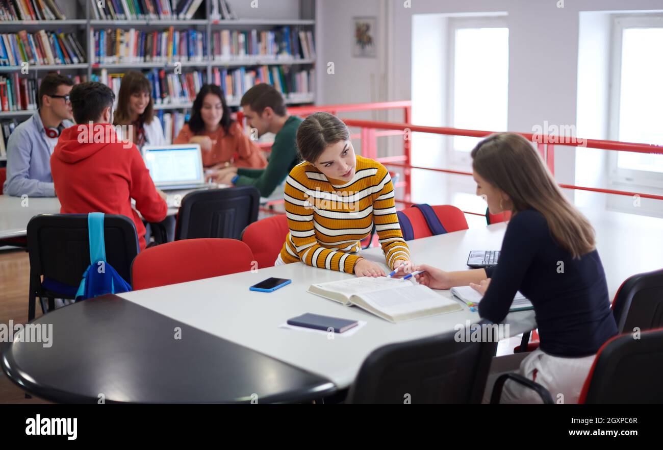 Elibrary Project For Students a group of students sit in a library and create a project for a school ...