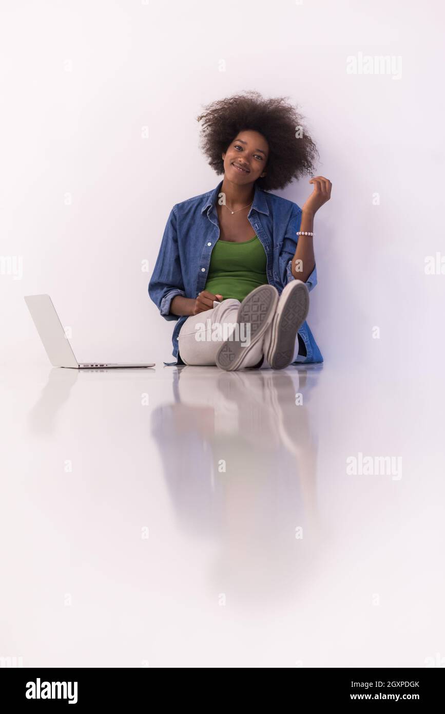 Portrait of happy young african american woman sitting on floor with ...