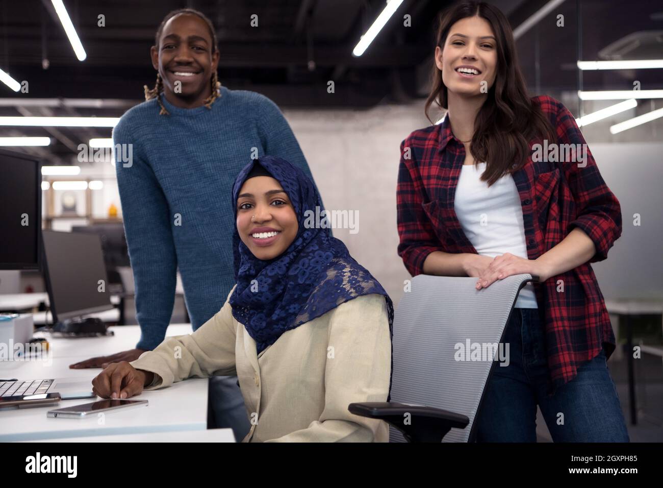 young multiethnics business team of software developers working together using laptop computer while writing programming code at modern startup office Stock Photo