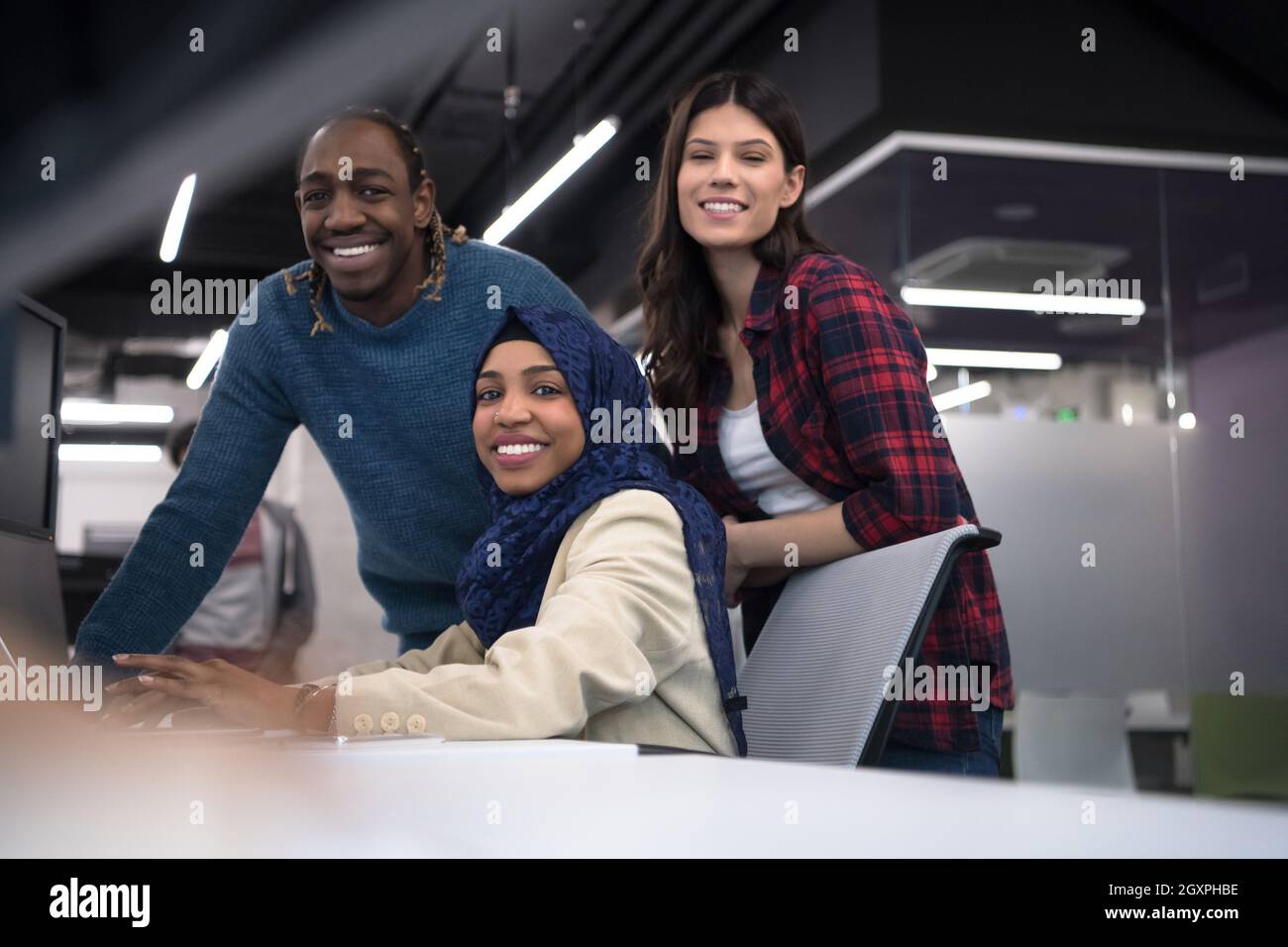 young multiethnics business team of software developers working together using laptop computer while writing programming code at modern startup office Stock Photo