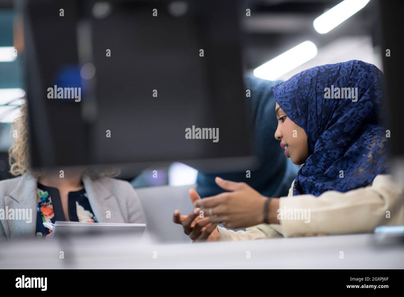 black muslim female software developer working together with her ...