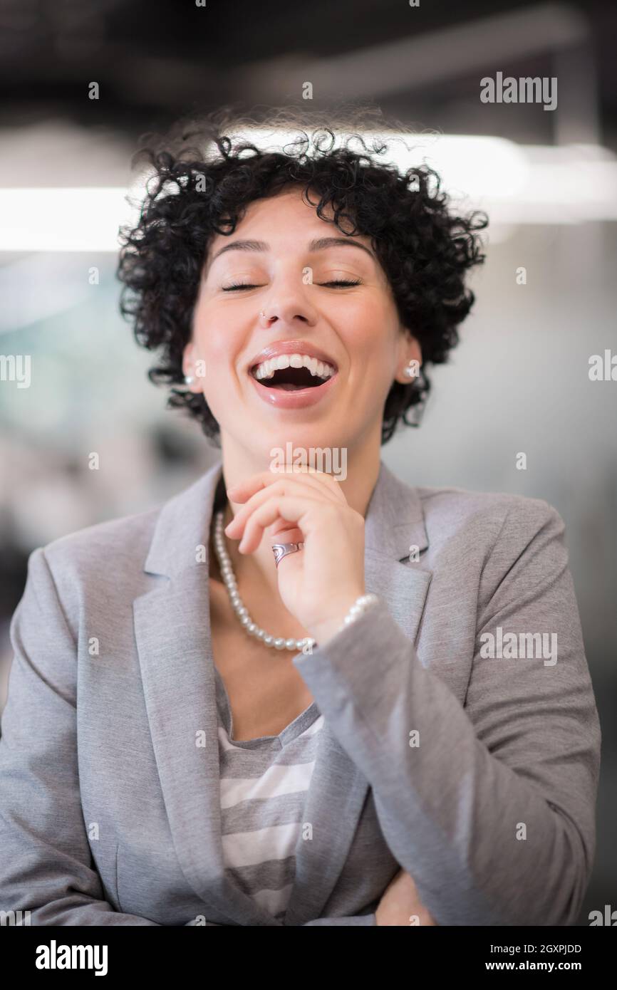 Portrait of successful female software developer with a curly hairstyle at modern startup office Stock Photo - Alamy Portrait of successful female software developer with a curly hairstyle at modern startup office Stock Photo - Alamy