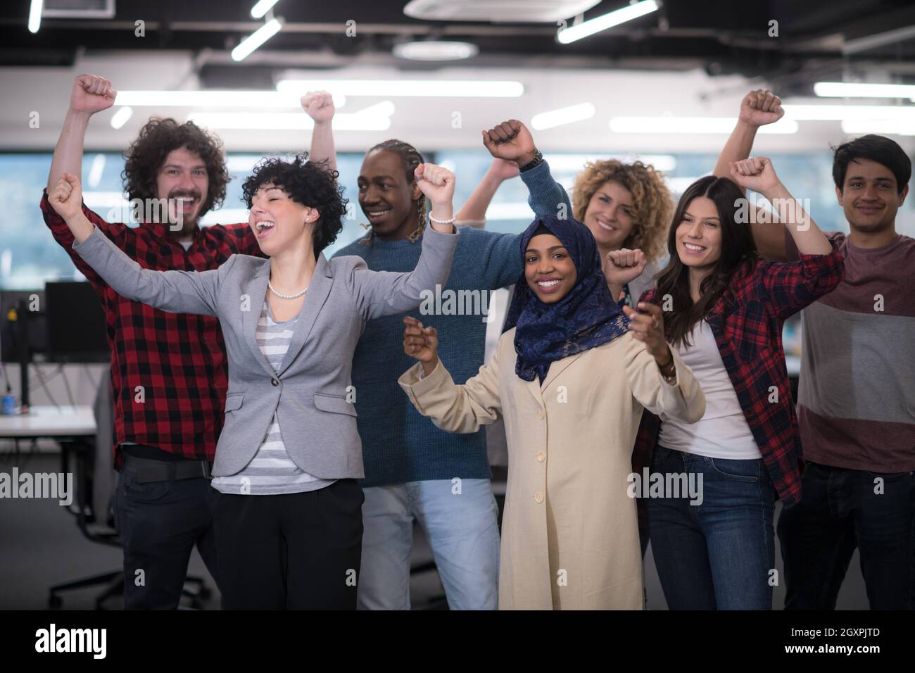 portrait of young excited multiethnics business team of software ...