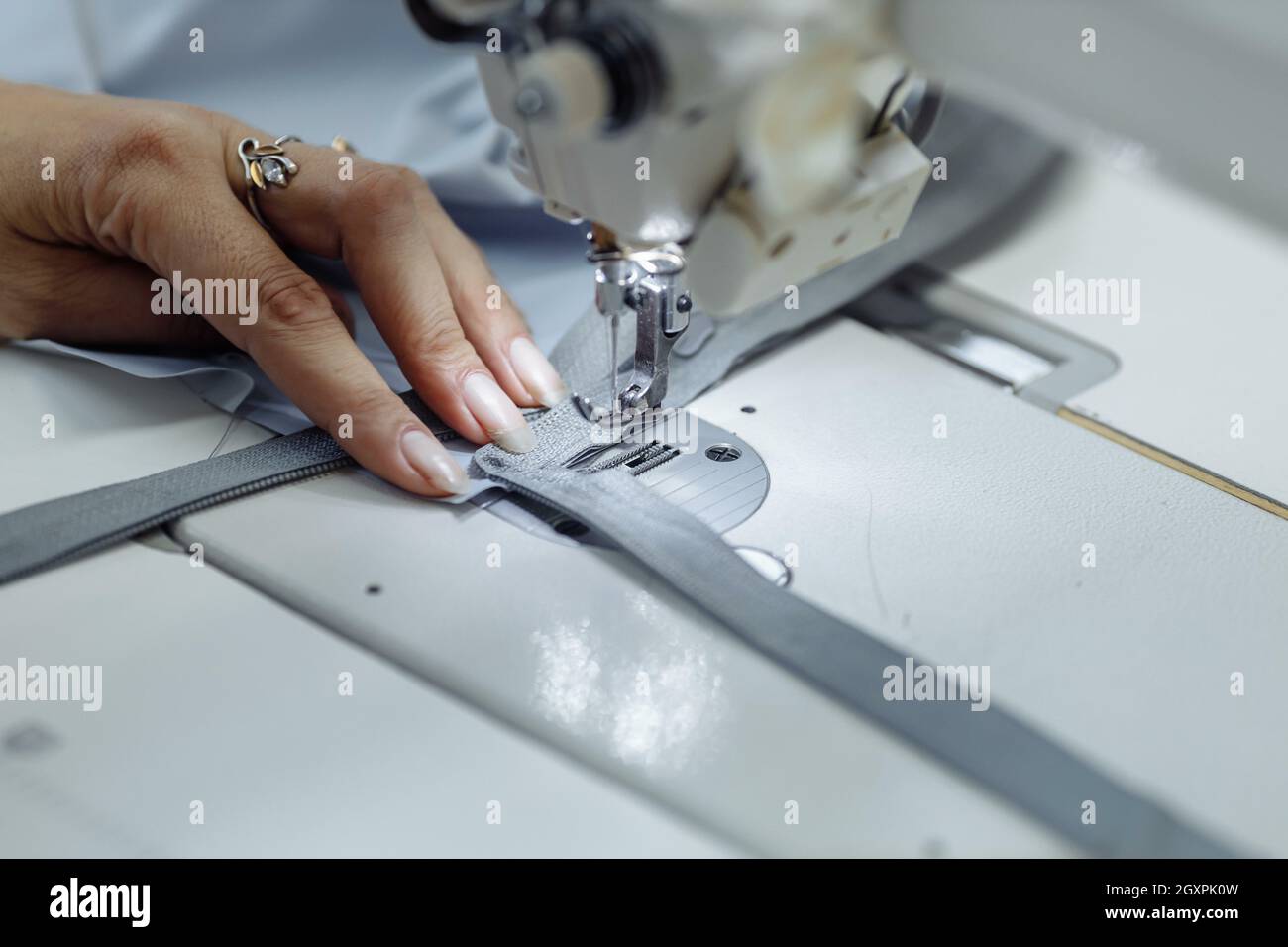 sewing machine scribbling fabric. tailoring at the factory Stock Photo