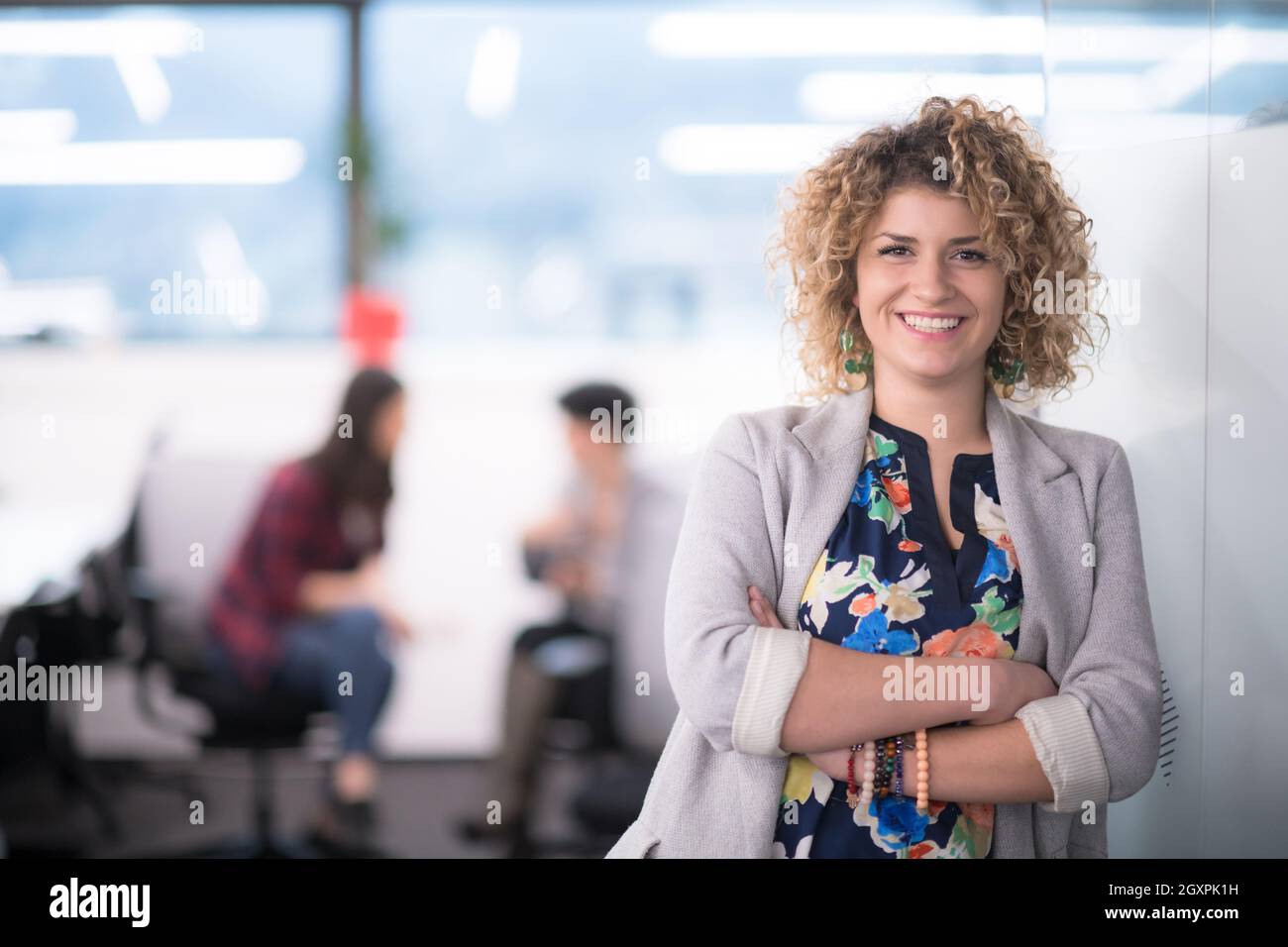Portrait of successful female software developer with a curly hairstyle ...
