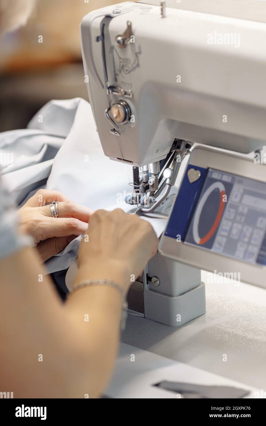 sewing machine scribbling fabric. tailoring at the factory Stock Photo