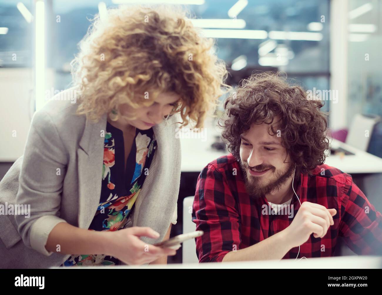 young software developers couple using laptop and desktop computer while writing programming code at modern creative startup office Stock Photo