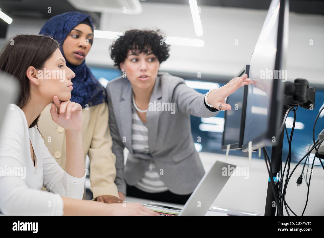 young multiethnics business team of software developers working ...