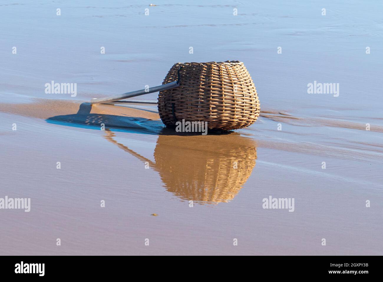 https://c8.alamy.com/comp/2GXPY3B/reflections-of-vintage-fishing-creel-on-water-in-marau-state-of-bahia-brazil-2GXPY3B.jpg