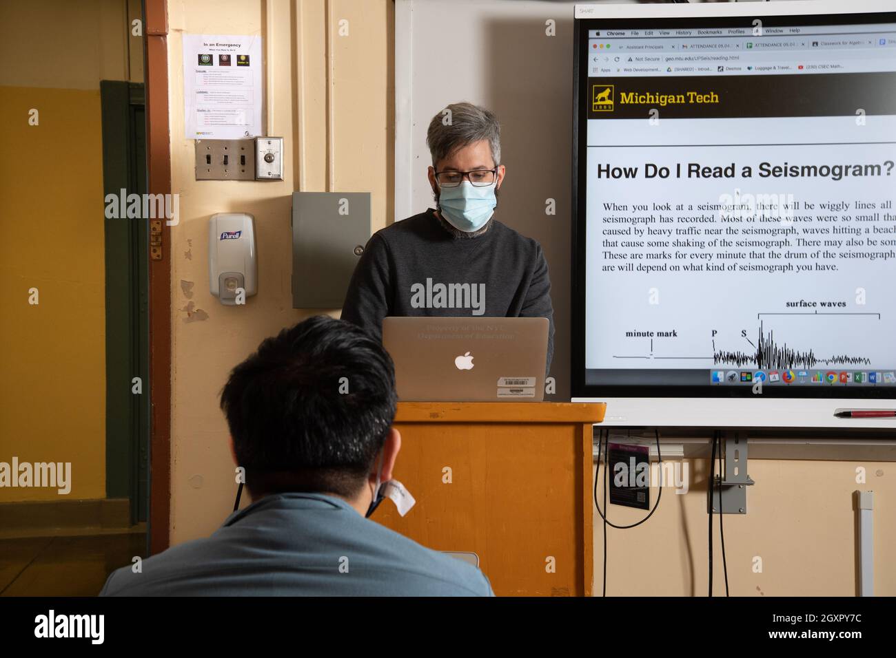 Education High School classroom male teacher presenting lesson on smart