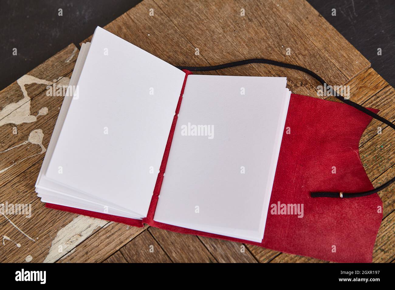 Blank Spiral Sketchbook with White Pages Against Colorful Abstract