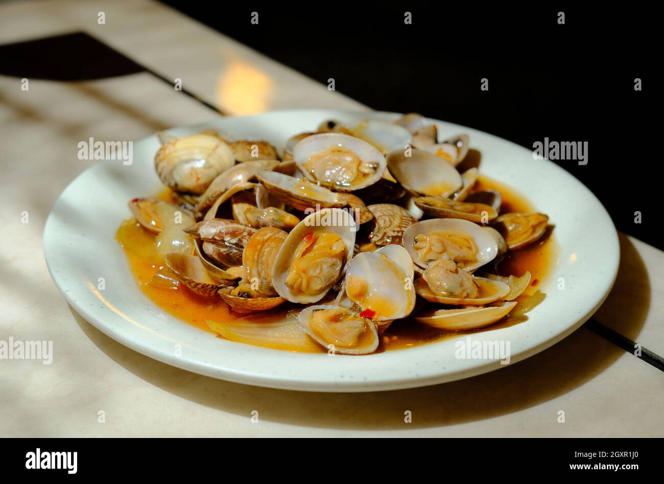 Chinese baby clams on the shell with black bean sauce Stock Photo Alamy