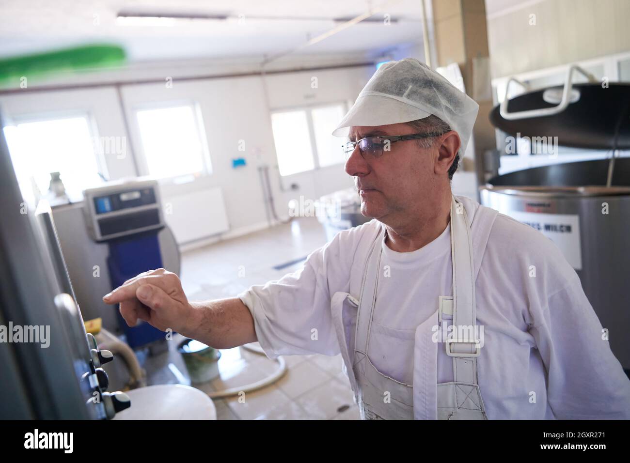 Cheese production male cheesemaker employee working in factory Stock ...