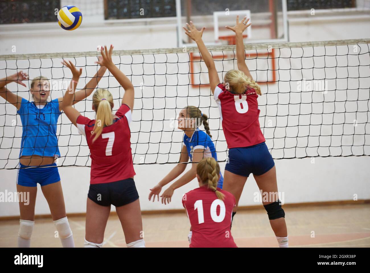 volleyball game sport with group of young beautiful girls indoor in