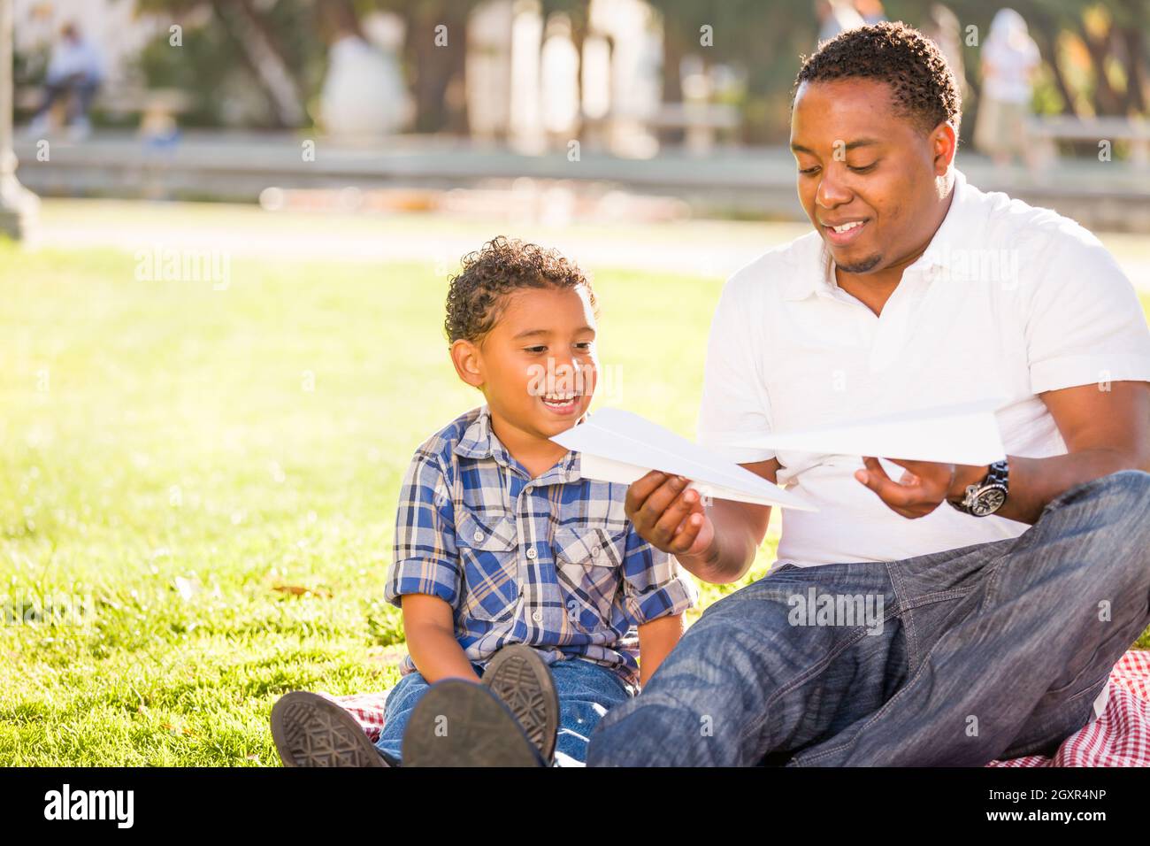 Happy African American Father and Mixed Race Son Playing with Paper ...