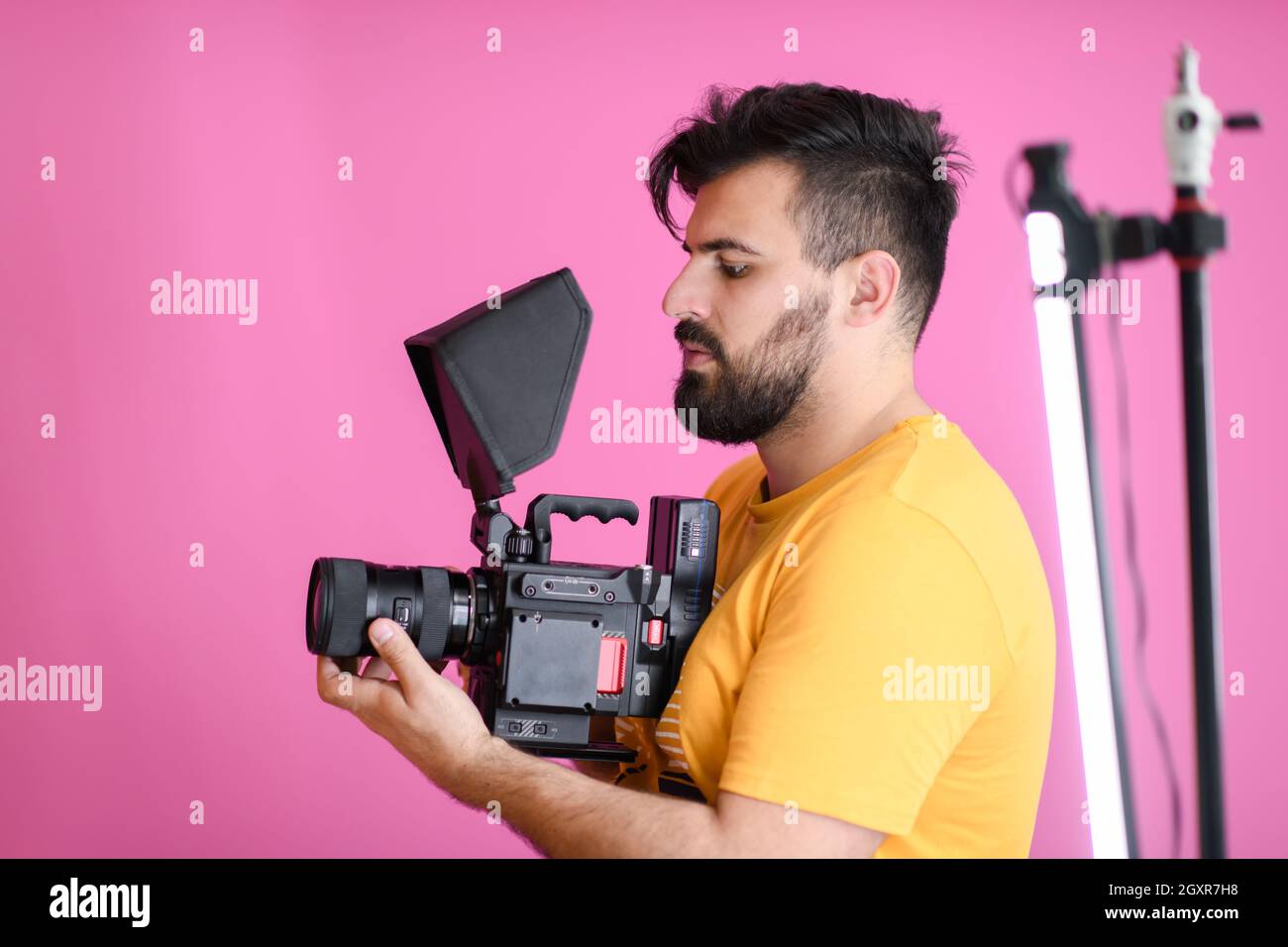 a cameraman with professional equipment shoots video clips in the studio Stock Photo