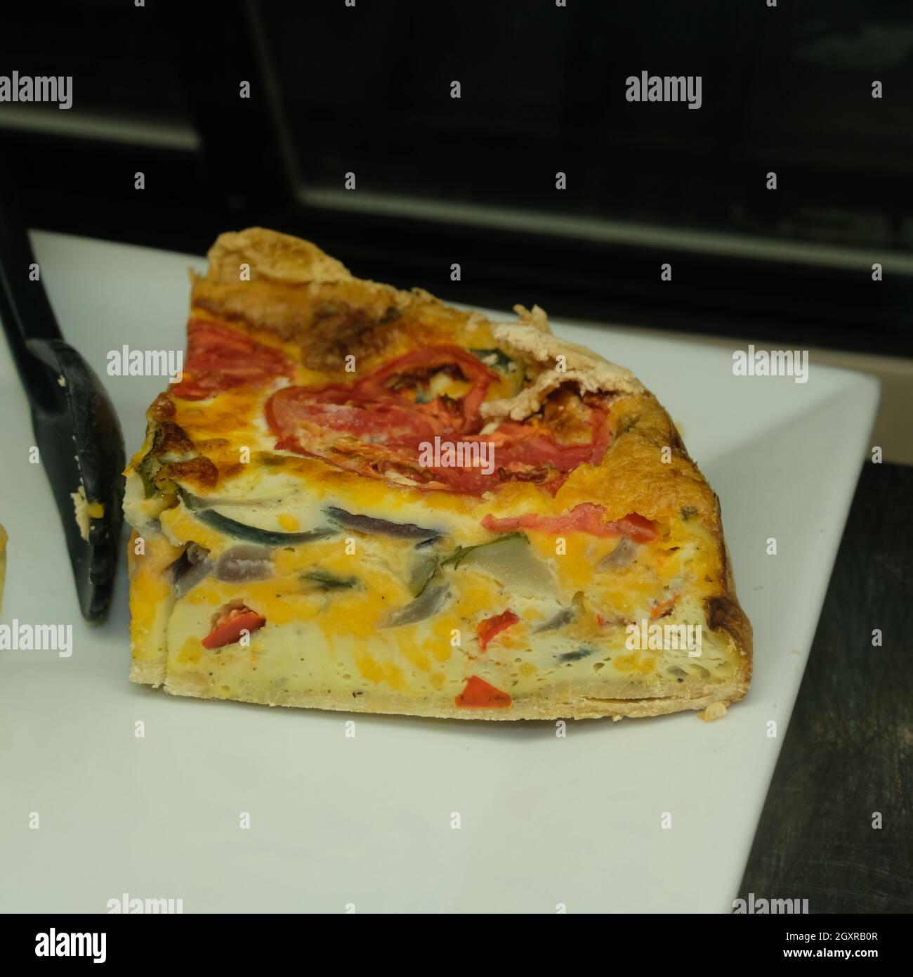 Healthy egg breakfast sliced quiche pie on display at local bakery