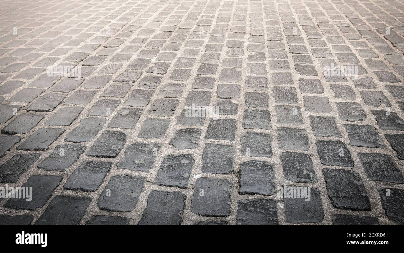 The Granite cobblestoned pavement background. Selective focus Stock Photo