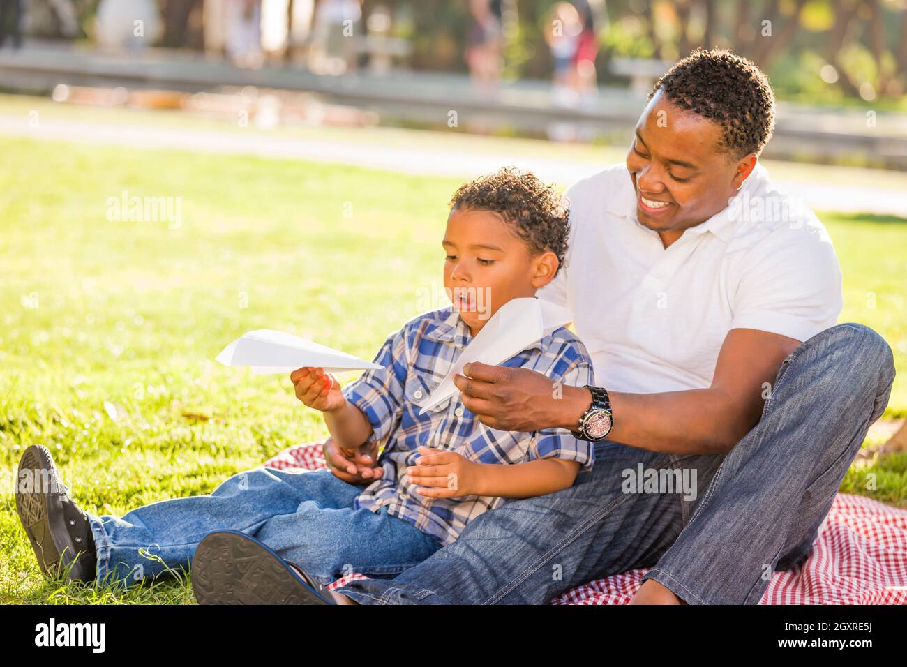 Happy African American Father and Mixed Race Son Playing with Paper ...