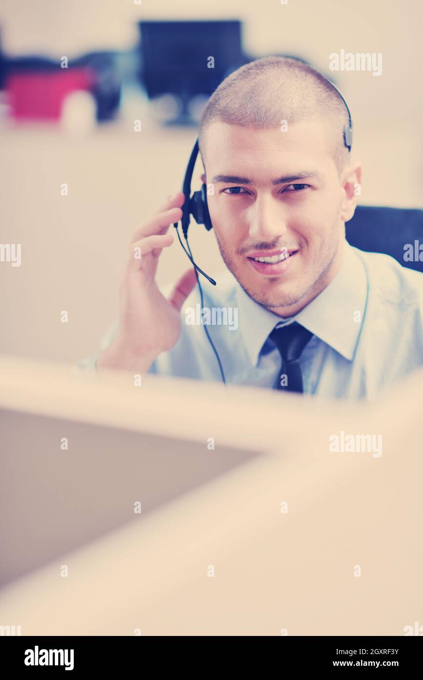 businessman with a headset portrait at bright call center helpdesk ...