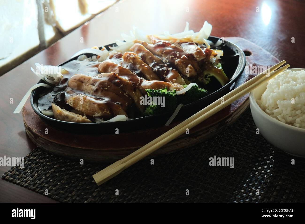 Japanese teriyaki chicken dinner served in cast iron hot plate Stock Photo  - Alamy