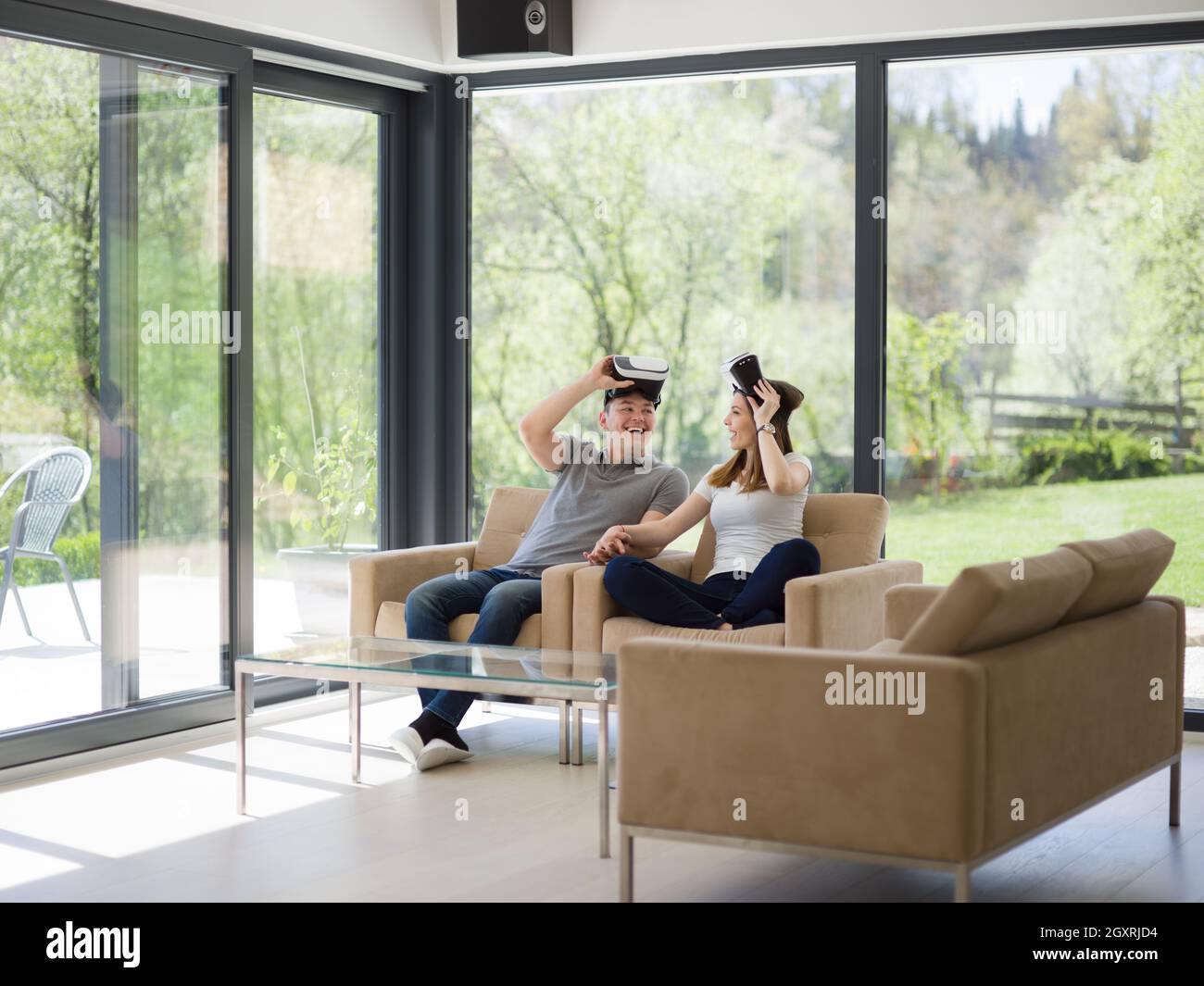 Couple using virtual reality headset in living room at home people ...