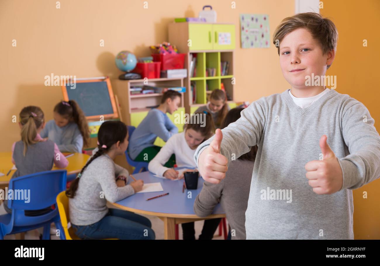 Schoolboy hold thumbs up, elementary age children drawing Stock Photo ...