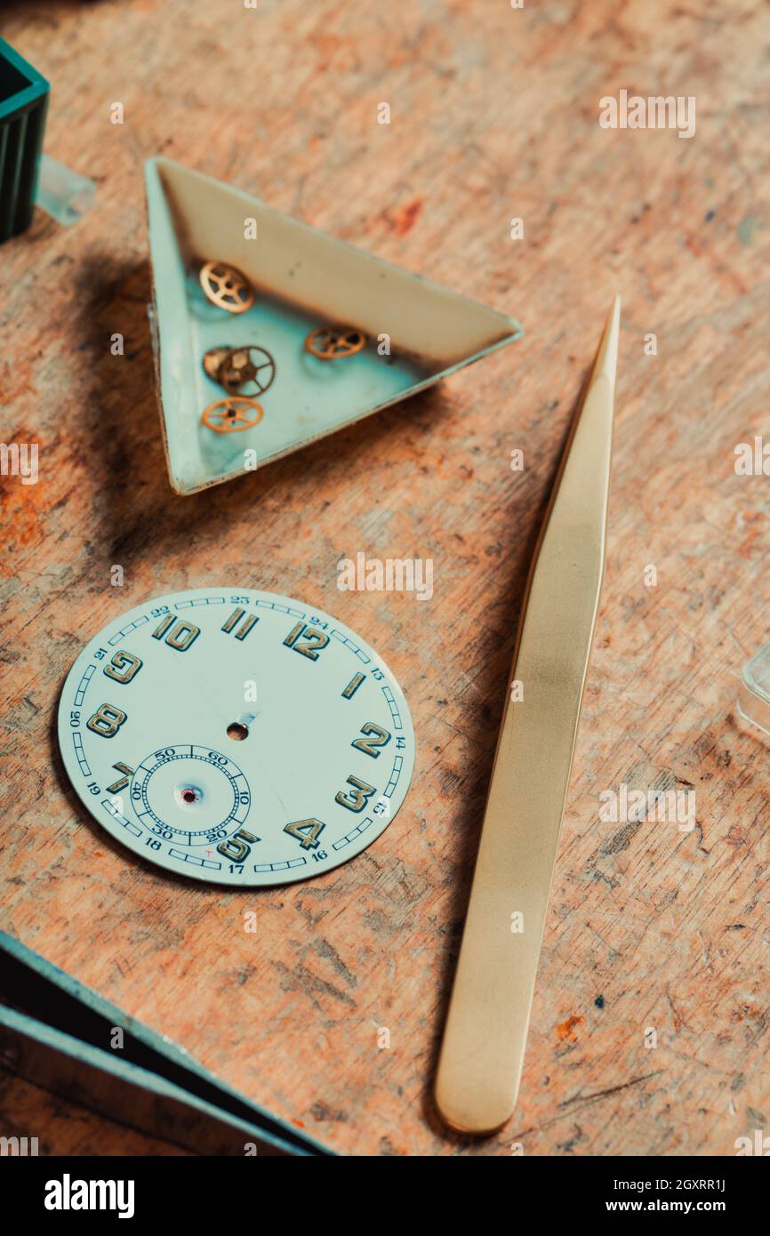 selective focus on dial or face of a watch, displayed on a watchmakers
