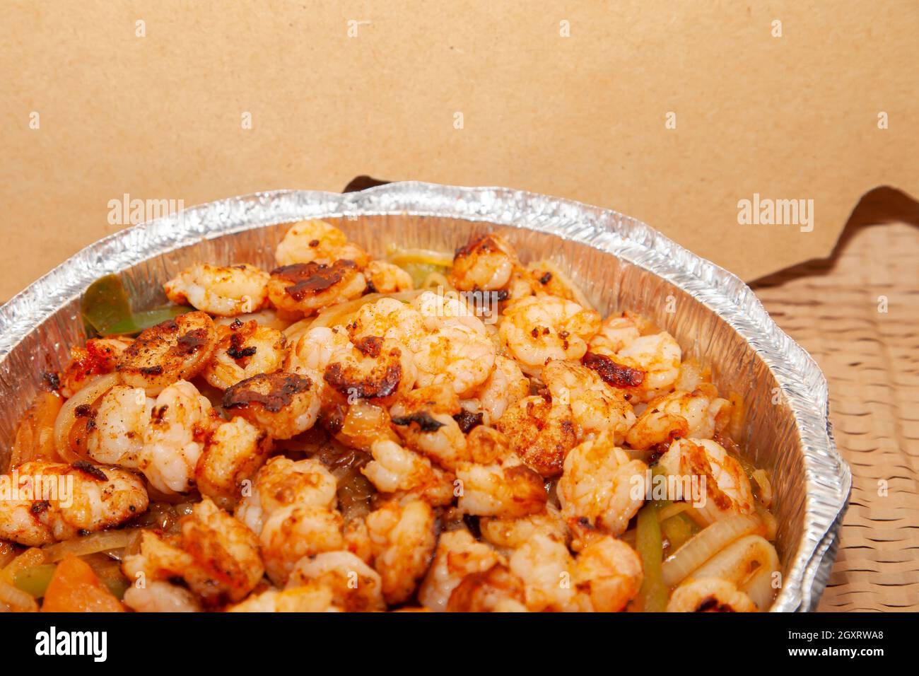 Ovenroasted shrimp and vegetables in a takeout tin Stock Photo Alamy