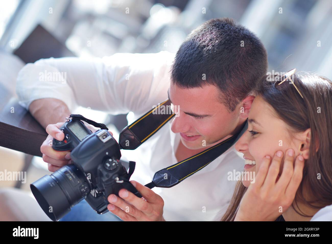 happy young romantic couple looking photos on camera Stock Photo - Alamy