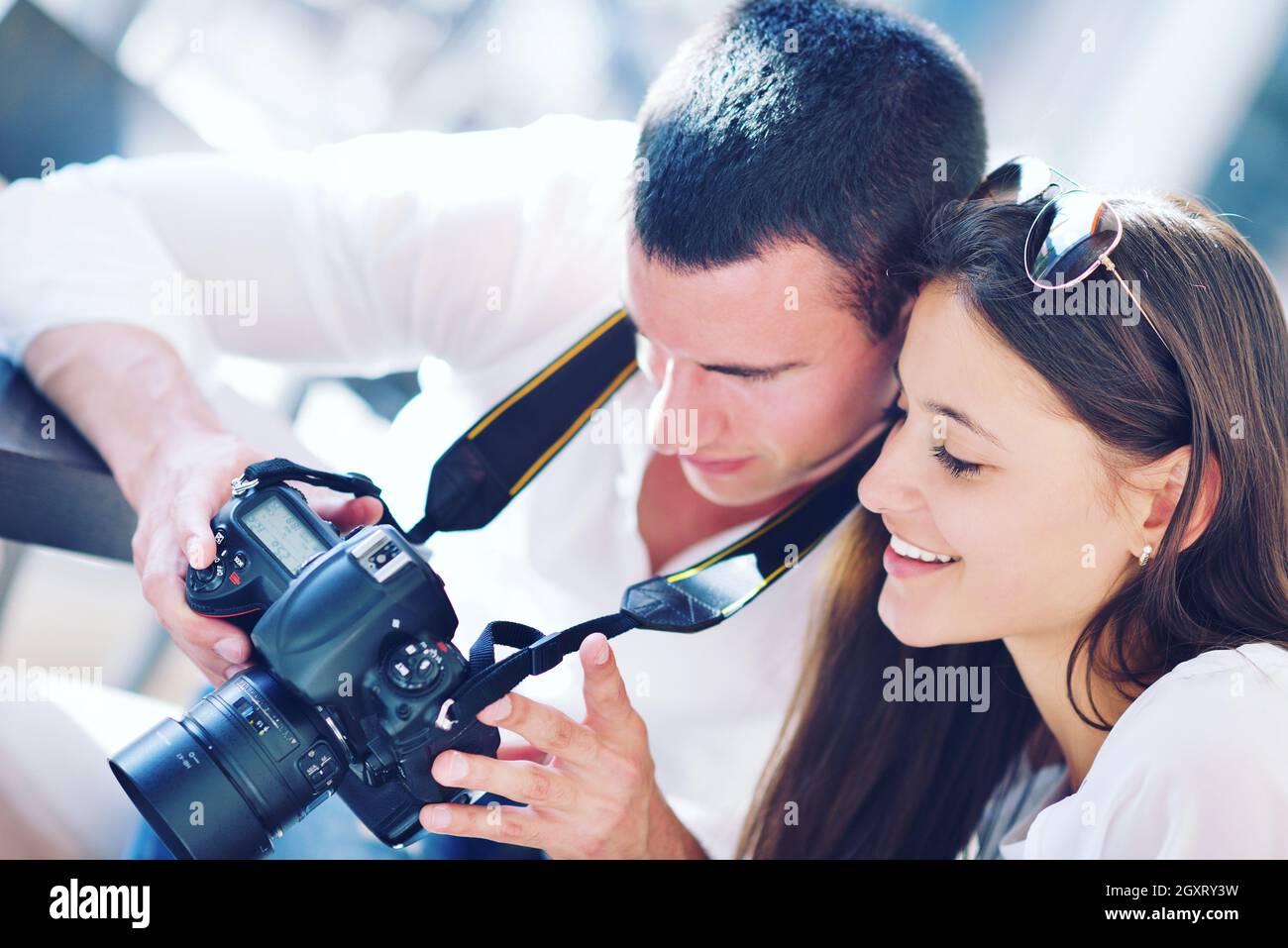 happy young romantic couple looking photos on camera Stock Photo - Alamy