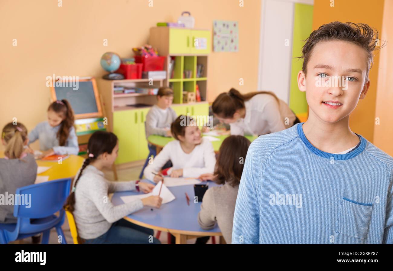 Happy schoolboy foreground in classroom with studying Stock Photo - Alamy