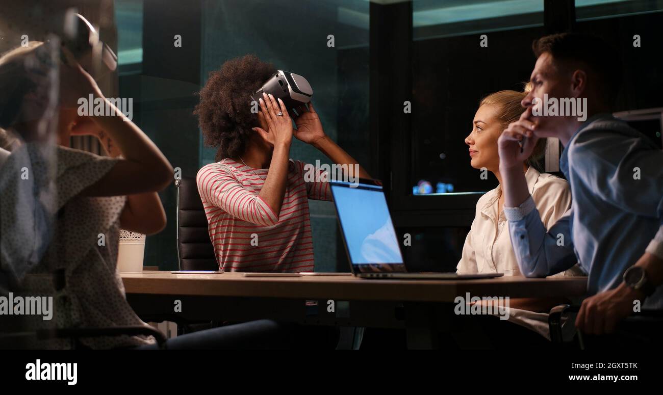 Meeting Simulation Multiethnic Business team using virtual reality headset in night office ...