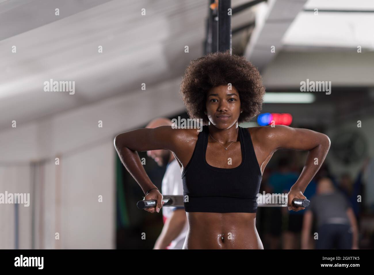 african american athlete woman workout out arms on dips horizontal parallel  bars Exercise training triceps and biceps doing push ups Stock Photo - Alamy