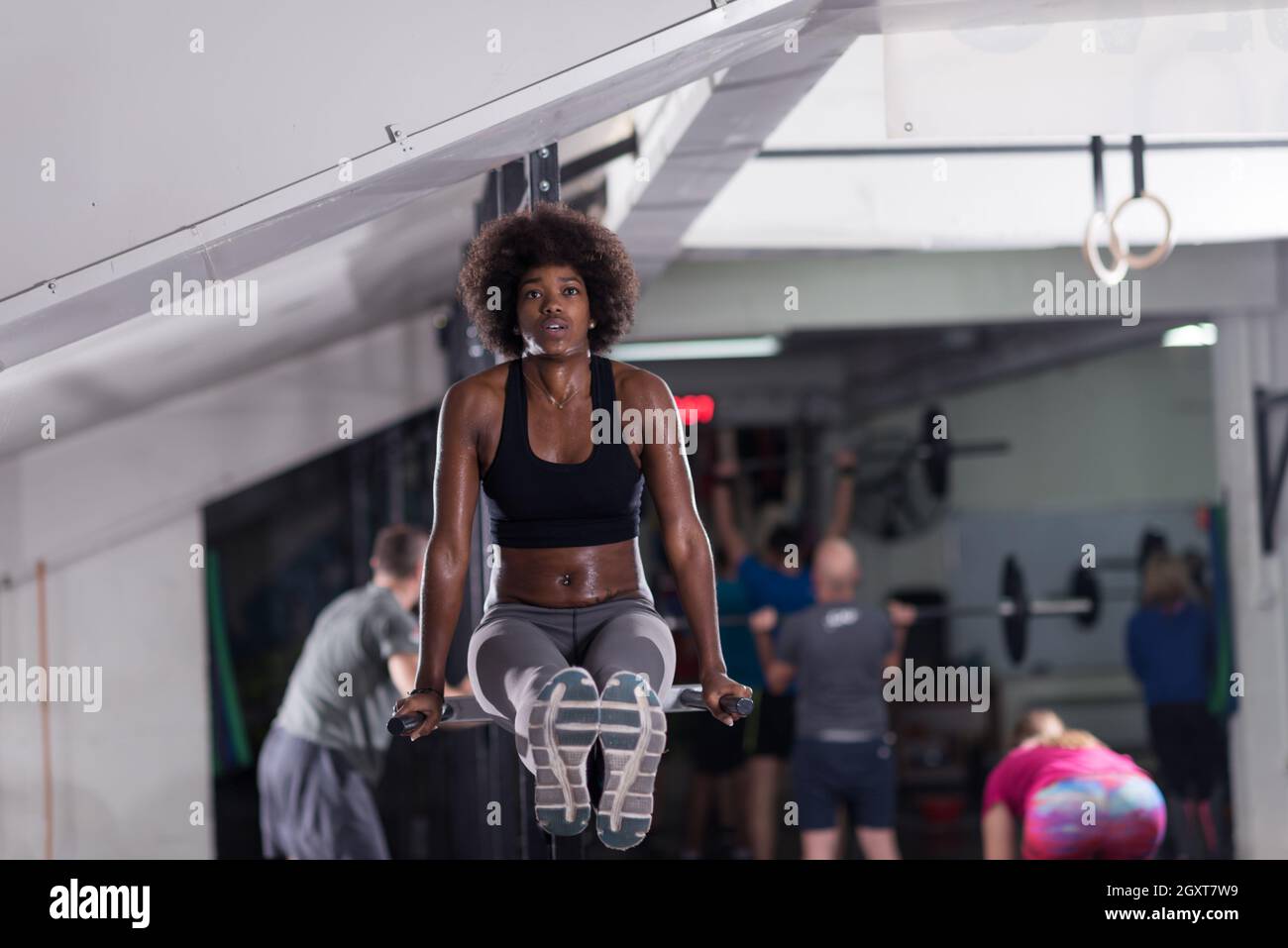 Women doing push ups training arms with trx straps in gym Stock Photo -  Alamy