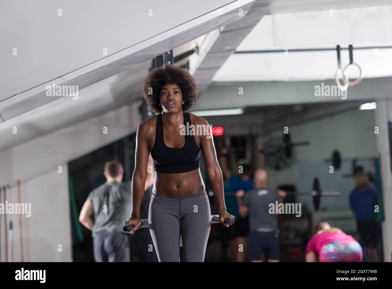 african american athlete woman workout out arms on dips horizontal parallel  bars Exercise training triceps and biceps doing push ups Stock Photo - Alamy