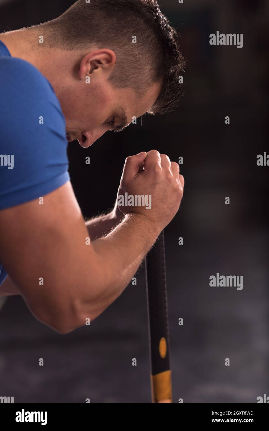 Sledgehammer Tire Hits young muscular man workout at gym with hammer
