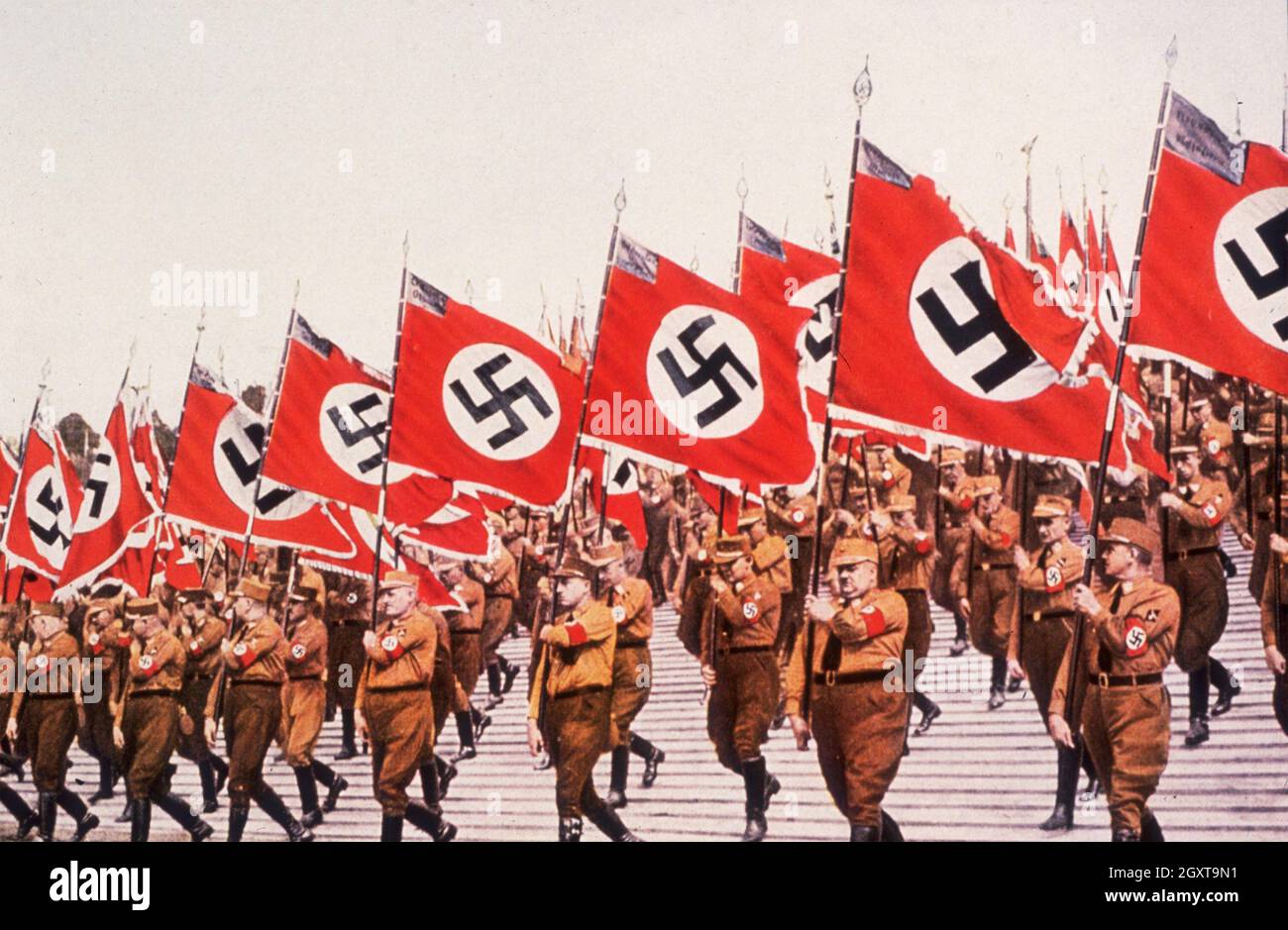Nazi brownshirts carrying swastika banners at the Nuremberg Rally Stock Photo