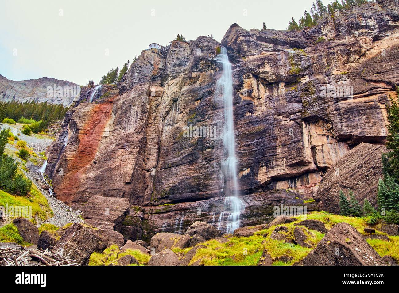 Large waterfall over vertical cliffs in mountains Stock Photo